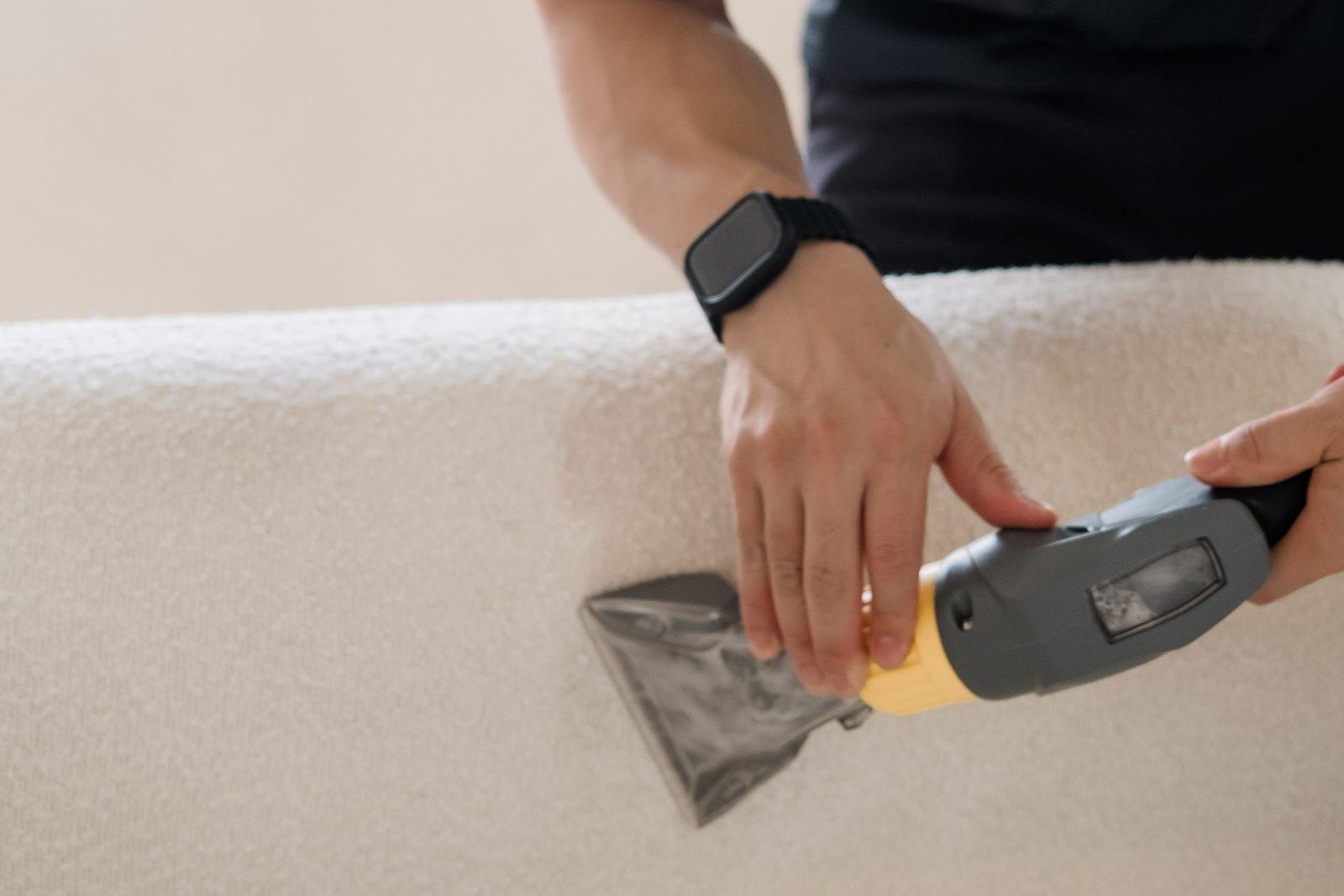 Cleancraft technician wet-extracting a fabric sofa arm
